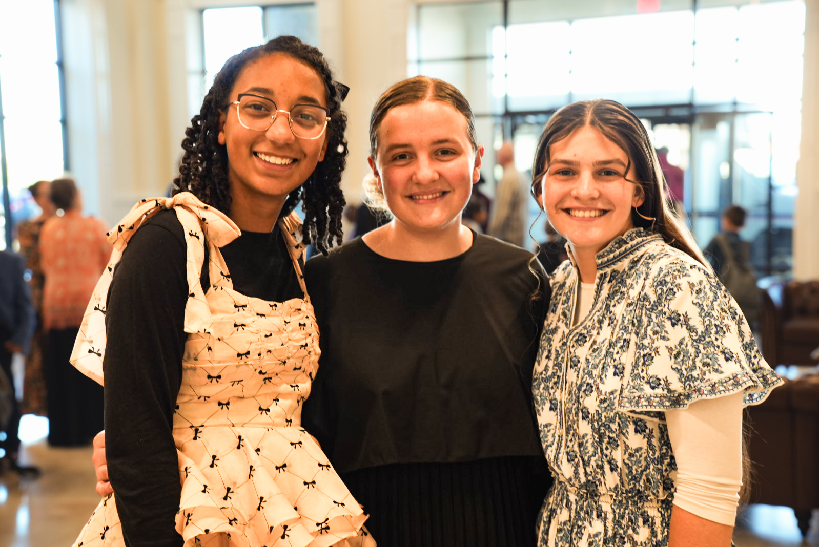 Friends smiling together in the church lobby